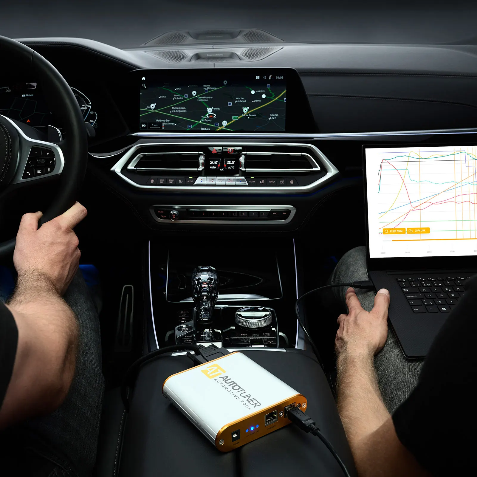 Technician using AutoTuner diagnostic tool inside BMW dashboard for key programming in Dallas